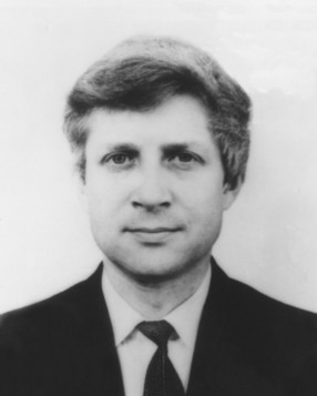 black-and-white archival portrait of a man in a suit